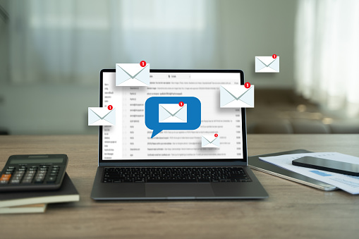 multifamily ai tools Open laptop on a desk with multiple email notifications displayed on the screen. Calculator and notebook are nearby. mpro Digital Edge