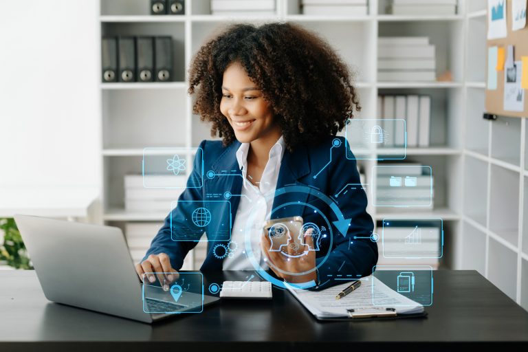 multifamily ai tools A woman in a suit works on a laptop at a desk, surrounded by digital icons and holograms. Bookshelves can be seen in the background. mpro Digital Edge